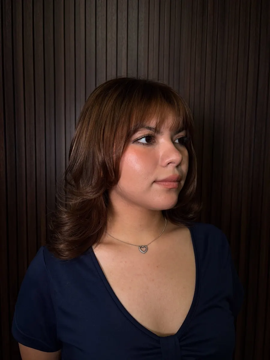 Dark blonde babylights and lowlights with curtain bangs