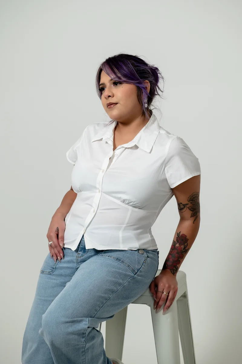 Sabrina Requejo, Platinum stylist, with violet hair, in a white blouse